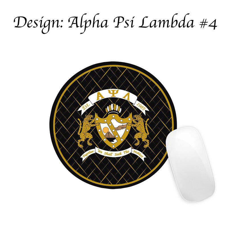 May include: A black and gold round mouse mat with a Greek fraternity crest featuring a shield with a mountain, a sun, and a hand reaching out. The crest is surrounded by two golden lions and a banner that reads "&Alpha; &Psi; &Lambda; Est. 1985 Together We Shall Seek The Noblest".
