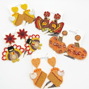 May include: Assortment of Thanksgiving themed beaded earrings.  The earrings feature designs of pumpkins, turkeys, pies, and hearts.  The earrings are made with colorful beads and are perfect for the fall season.