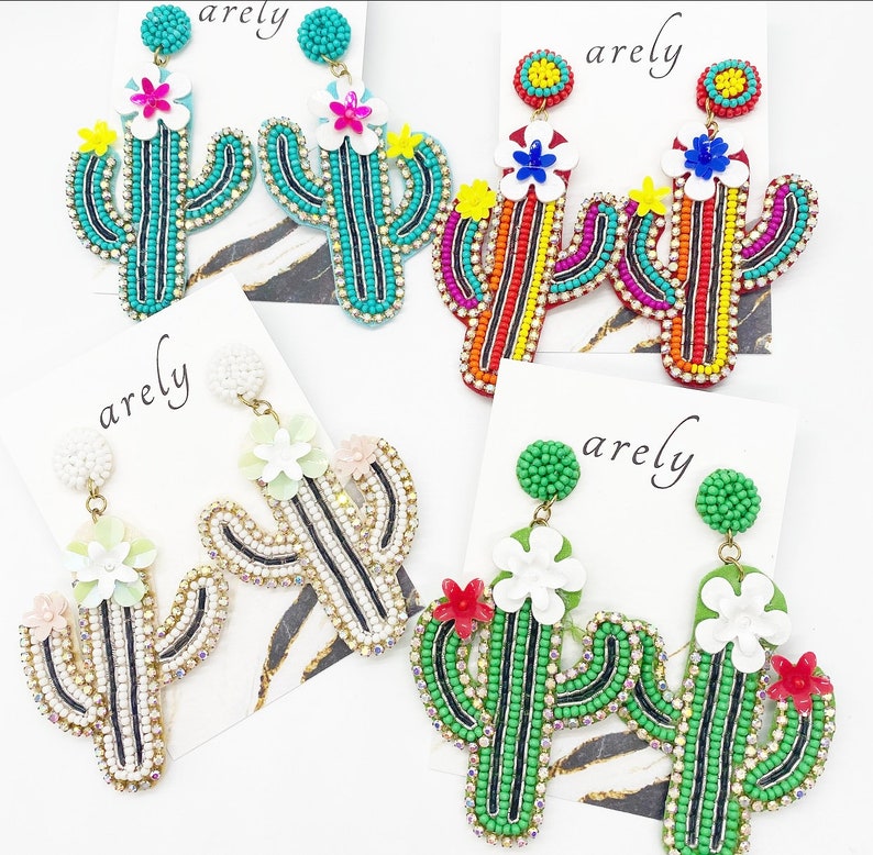 May include: Four pairs of beaded cactus earrings. Each pair features a different color scheme, including turquoise, red, white, and black. The earrings are all made with small beads and have a flower detail at the top.