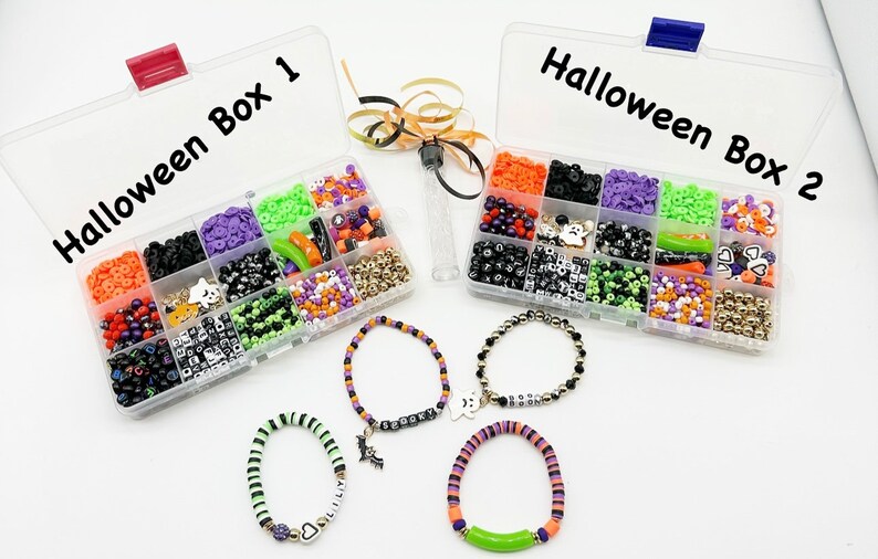 May include: Two clear plastic containers filled with colorful beads and charms labeled "Halloween Box 1" and "Halloween Box 2". Four bracelets made with beads and charms are displayed below the containers.
