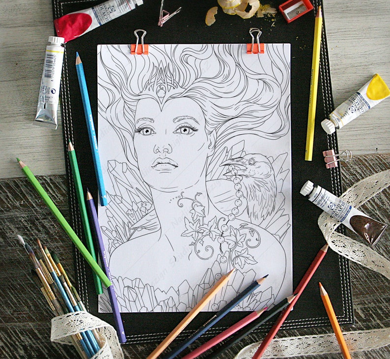 May include: A black and white line art coloring page featuring a woman with long flowing hair, a crown, and a raven perched on her shoulder. The woman is surrounded by crystals and vines.