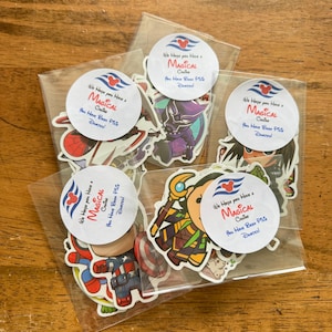 May include: A collection of individual stickers featuring various cartoon characters, each sealed in a clear plastic sleeve. Each sleeve has a circular white label with a red Mickey Mouse icon and the text We Hope You Have a MAGICAL Cruise You Have Been Pixie Dusted!