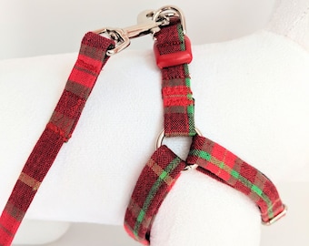 May include: Red and green plaid dog harness with a silver clip and leash.