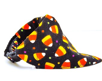 May include: Black fabric dog bandana with a candy corn print. The bandana has an adjustable buckle closure.