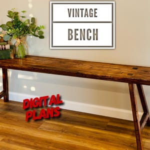May include: A rustic, wooden bench with a dark stain finish. The bench has angled legs and a rectangular top. The image includes the text "VINTAGE BENCH" and "DIGITAL PLANS". A vase of greenery and books are on the bench.