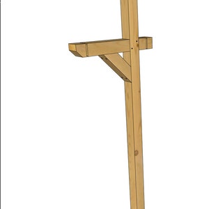 May include: A wooden mailbox post with a decorative top. The post is made of natural wood and has a simple, rustic design.