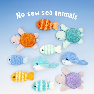 May include: A collection of handmade, no-sew sea animal plush toys in various colors. The image features crocheted fish, turtles, and whales in shades of orange, blue, green, and yellow. The text "No sew sea animals" is displayed at the top.