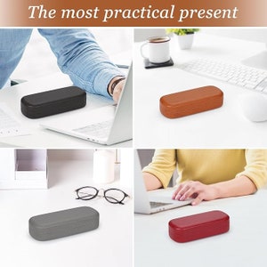 May include: A collage of four rectangular eyeglass cases in black, brown, gray, and red. The cases are shown on a white surface with a laptop, glasses, and the text "The most practical present" at the top.