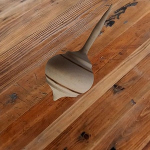 Spinning top hand lathed from natural hazelnut wood