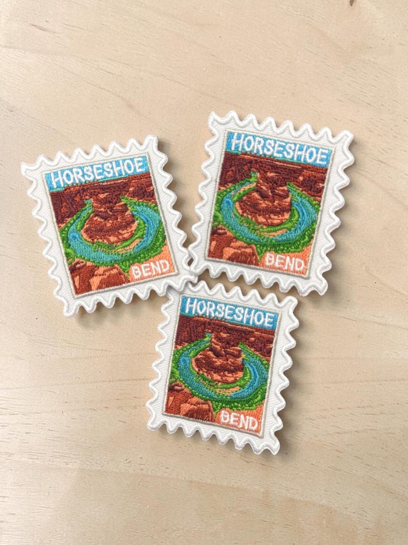 May include: Three rectangular embroidered patches shaped like postage stamps with scalloped edges. Each patch features a landscape illustration of Horseshoe Bend with a winding blue river, red rock formations, and the text HORSESHOE BEND.