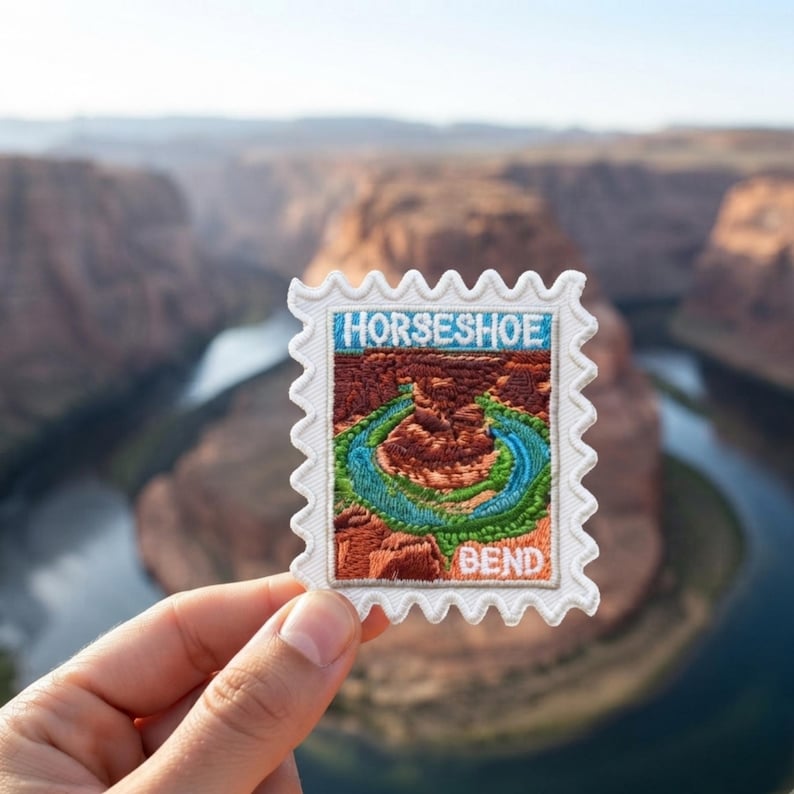 May include: A rectangular embroidered patch with a scalloped edge, featuring a detailed landscape of Horseshoe Bend. The design includes a winding blue river surrounded by red rock canyon walls, with the text HORSESHOE BEND stitched in white.