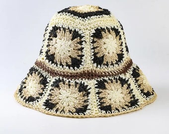May include: A crocheted bucket hat with a brown, black, and white geometric pattern.
