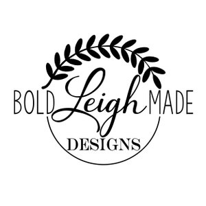 May include: Black and white logo with a wreath of leaves around the text "BOLD Leigh MADE DESIGNS".