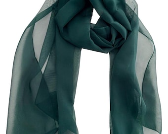 May include: A solid dark emerald green scarf made of a lightweight, sheer, and translucent fabric. The scarf is draped in a loose, flowing arrangement, showcasing the semi-transparent quality of the material and its deep, consistent green color.