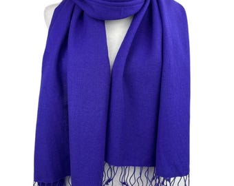 May include: A solid royal blue pashmina scarf with fringed edges.