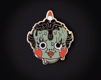 Wax doll gold enamel pin