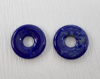 May include: Two blue lapis lazuli donut shaped beads with gold flecks.