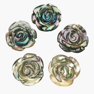 May include: Five iridescent abalone shell rose-shaped beads. The beads display a range of colours, including green, blue, and purple, with a pearlescent sheen. The rose petals are intricately carved, creating a detailed floral design.