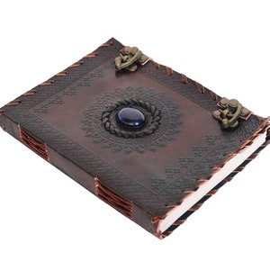 Handmade Refillable tan Brown Premium leather bound journal Magic mystical feature Blue stone rustic embossed, secured with leather string closure, ideal spell book, travel diary, rustic guest book, rest on vintage table with pen.