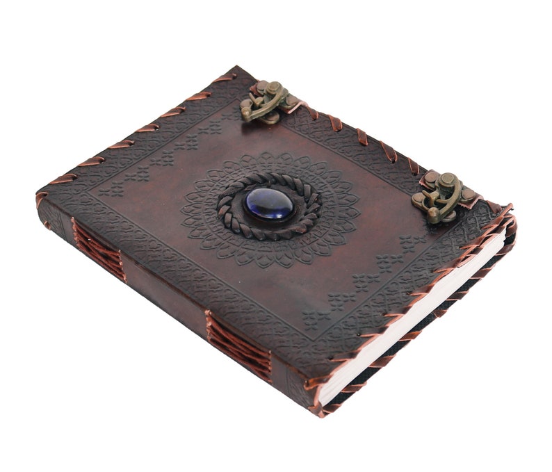 Handmade Refillable tan Brown Premium leather bound journal Magic mystical feature Blue stone rustic embossed, secured with leather string closure, ideal spell book, travel diary, rustic guest book, rest on vintage table with pen.