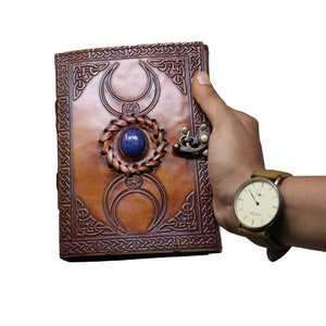 Showcase Rustic vintage leather journal size of occult book with a visual of it being carried. Compact at 7 x 5 x 1.5 inches, fits effortlessly in hands for a stylish experience to gift on Christmas, Birthday, Anniversary or Valentine's day.