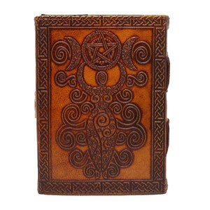 Handmade Brown Genuine leather bound journal Book of shadows grimoire featuring Triple Moon emboss, secured with swing clasp closure, showing blue stone ideal as spell book, travel dairy, rustic guestbook, rest on vintage table with a pen.