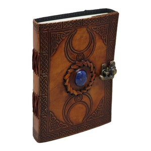 Handmade Brown leather-bound journal  Rustic Guestbook spell book featuring Triple Moon emboss secured with a clasp closure, showing Coptic binding and blue stone. The book stands tall, no bleed through high quality handmade pages elegantly aligned.