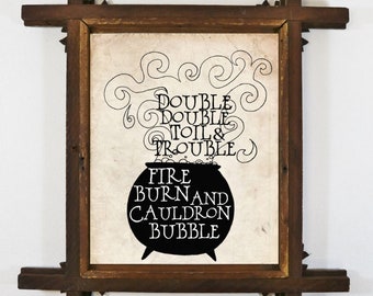 May include: A framed print with a black silhouette of a cauldron with steam rising from it. The text reads "Double Double Toil & Trouble Fire Burn and Cauldron Bubble".