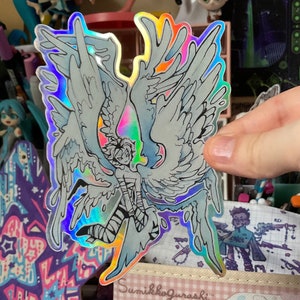 Pegatina de vinilo holográfico brillante con piloto alado.