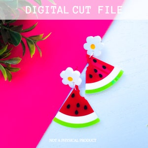 May include: A pair of watermelon slice earrings with white flower accents. The earrings are made of acrylic and are a bright red, green, and white.