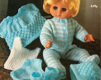 May include: A blue and white striped knitted outfit for a doll, including a hat, booties, and a sweater. The doll is wearing the outfit and has blonde hair and blue eyes. The image is from a knitting pattern book.