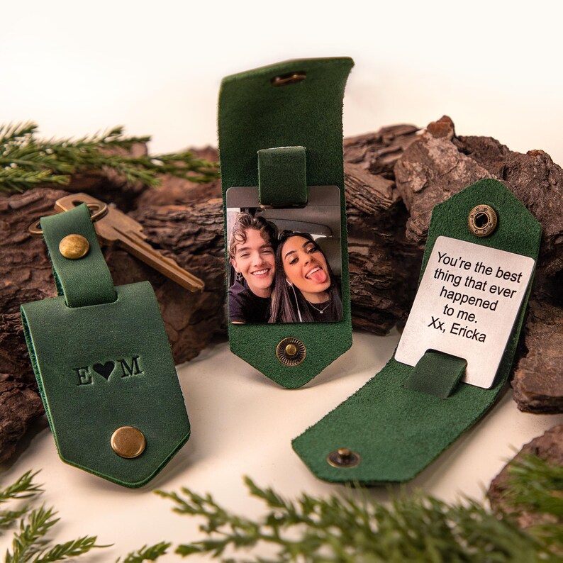 May include: Green leather keychains with metal accents. One keychain has the initials E&hearts;M embossed. Another keychain displays a photo of a couple. The third keychain has the text "You're the best thing that ever happened to me. Xx, Ericka."
