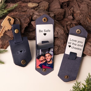 May include: Navy blue leather keychain with embossed initials and a heart. Two navy blue leather cardholders with metal inserts. One cardholder reads "Be Safe" with a heart, the other reads "Love you till the end cheeks" with a heart. Each cardholder has a photo.