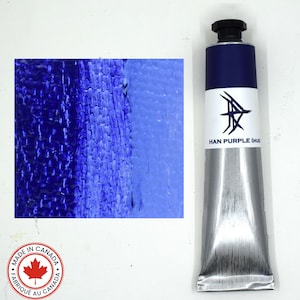 May include: A metal paint tube labeled Han Purple (Hue) with a black cap, featuring a white label with a dark blue logo. Beside the tube is a rectangular swatch showing a gradient of deep violet to light blue paint texture on canvas.