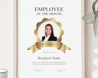 May include: An Employee of the Month award certificate in a light wood frame. It features a gold circular emblem with a portrait of a person, the text SEPTEMBER 2027, and a space for a recipient name, company appreciation text, and two signature lines.