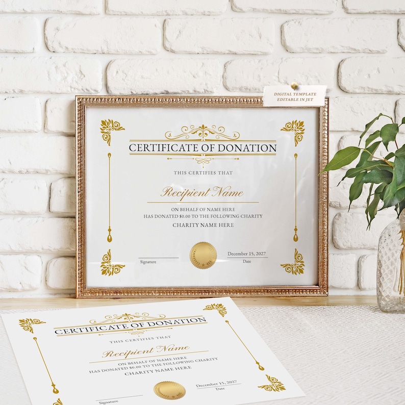 May include: A framed certificate of donation with gold accents and text. The certificate includes the words "Certificate of Donation" and "Recipient Name". A second certificate lies below the framed one.