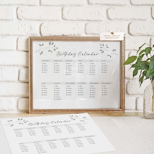 May include: A framed "Birthday Calendar" print with a gold-colored frame, displayed on a white surface. The calendar features a minimalist design with a floral motif and a list of names and dates. A loose print of the same calendar is in the foreground.