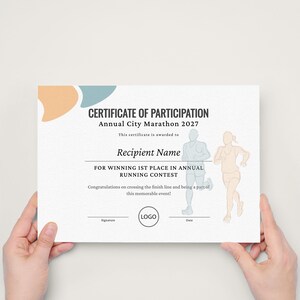 May include: A white certificate of participation for the Annual City Marathon 2027 featuring text, a logo placeholder, and line art illustrations of two runners in blue and peach. The document includes spaces for a recipient name, signature, and date.