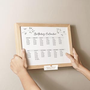 May include: A white ceramic mug with a black handle and the text "But First, Coffee" in a black, handwritten-style font. The mug is on a white surface.