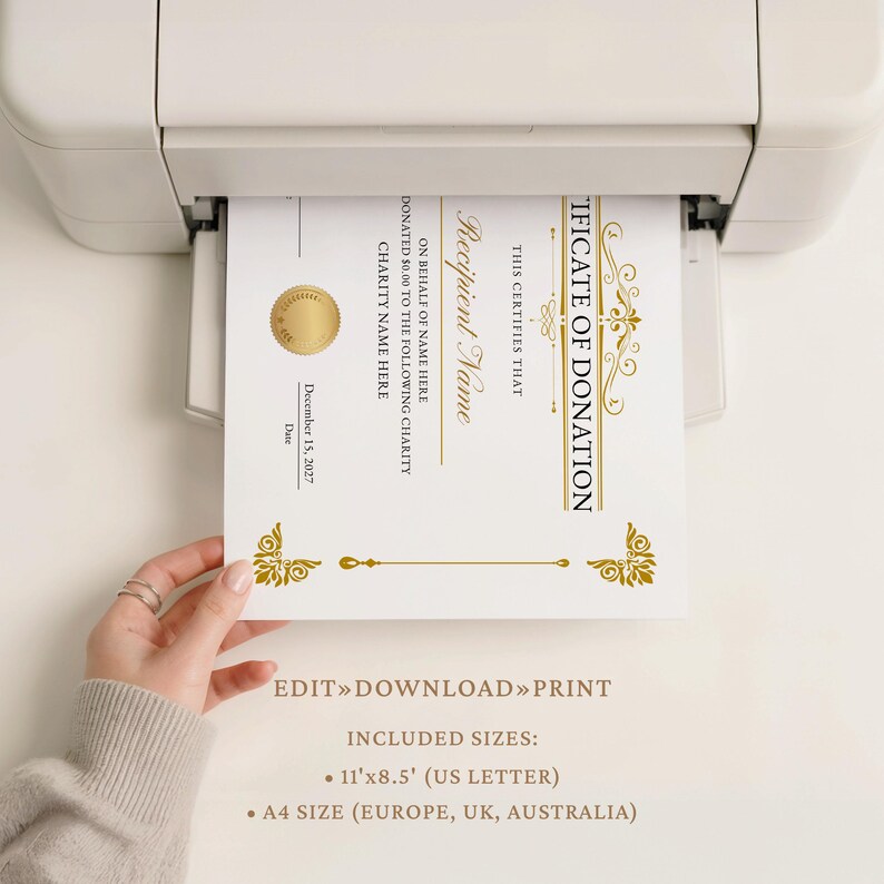 May include: A certificate of donation being printed from a printer. The certificate has gold accents and text that reads "Certificate of Donation" and "Recipient Name". The document includes the date December 15, 2027, and is 11"x8.5" in size.