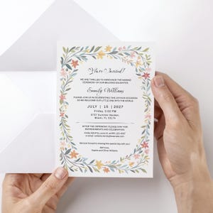 May include: A white rectangular invitation card featuring a floral border of green leaves and small flowers in shades of yellow, pink, and blue. The text reads: You're Invited! We are thrilled to announce the naming ceremony of our beloved daughter, Emmily Williams. Please join us in celebrating this joyous occasion as we welcome our little one into the world. July 15, 2027, Friday, 3:00 PM, 9757 Summer Garden, Miami, FL 33174. After the ceremony, please stay for refreshments and celebration. Kindly RSVP by June 10, at 655-123-4567 or email: williams.family@example.com. We look forward to sharing this special day with you! With love, Sophie and Oliver Williams.