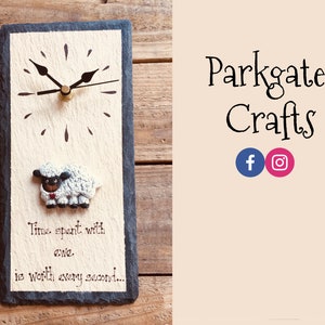 May include: A white and black sheep clock with a black clock face and gold hands. The clock is made of slate and has a white background with the text "Time spent with ewe is worth every second..."