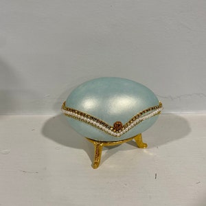 Vintage baby blue hand painted and jeweled egg on tripod stand