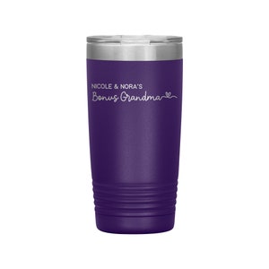 May include: Purple stainless steel tumbler with a white inscription that reads "Nicole & Nora's Bonus Grandma" with a heart symbol.