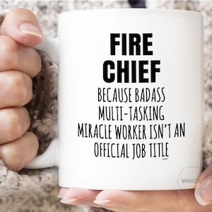 May include: White ceramic coffee mug with black text that reads "FIRE CHIEF BECAUSE BADASS MULTI-TASKING MIRACLE WORKER ISN'T AN OFFICIAL JOB TITLE".