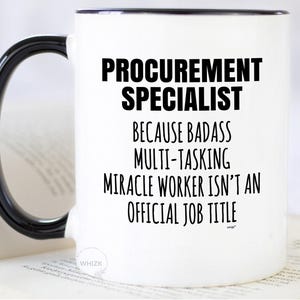 May include: A white ceramic mug with a black handle and black interior rim. The front features black text that reads: PROCUREMENT SPECIALIST BECAUSE BADASS MULTI-TASKING MIRACLE WORKER ISN'T AN OFFICIAL JOB TITLE. A small logo is visible at the bottom.