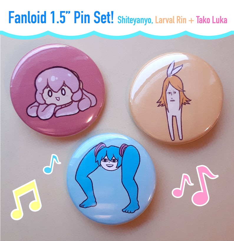 May include: A set of three 1.5-inch round pinback buttons. Each button features a cartoon character design in pink, peach, and blue. The text "Fanloid 1.5" Pin Set! Shiteyanyo, Larval Rin + Tako Luka" is at the top. Musical notes are in the background.