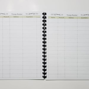 May include: Open spiral-bound notebook with the words "Troop Roster" at the top of each page. The pages are divided into columns labeled "Name," "Phone #," "Address," and "Guardians." The notebook is open, displaying two facing pages with a grid of blank lines.