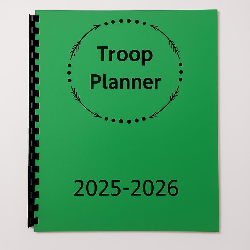 May include: A green spiral-bound planner with the words "Troop Planner" in black, encircled by a dotted line with arrows. The year range "2025-2026" is printed below. The planner is designed for organizing troop activities.