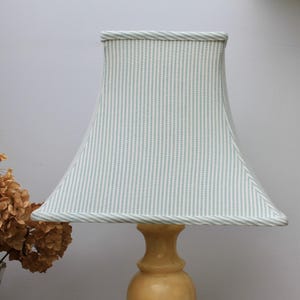 May include: A set of three ceramic mugs with a speckled, matte finish in cream, light grey, and dark grey. Each mug has a simple, minimalist design and a rounded handle.